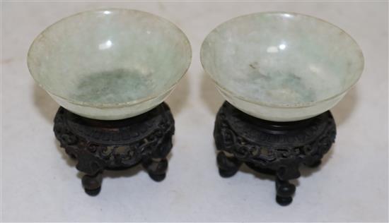 A pair of Chinese ice white and pale green jadeite bowls, early 20th century, diameter 7cm